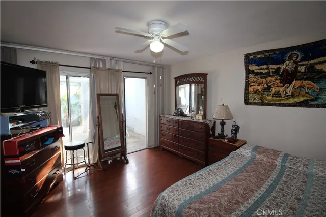 a bedroom with furniture and a flat screen tv