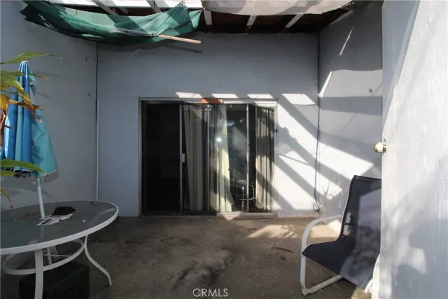 a backyard of a house with table and chairs