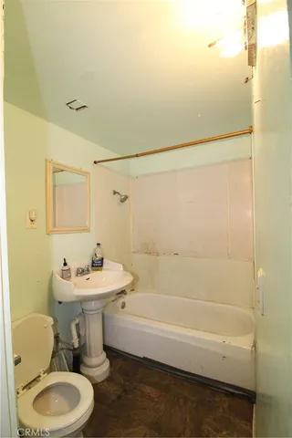 a bathroom with a sink mirror toilet and bathtub