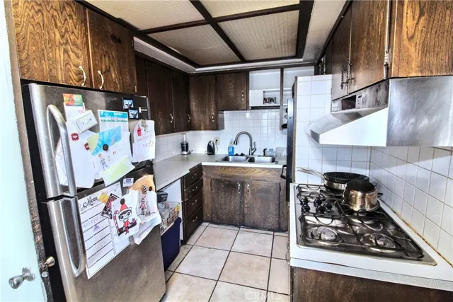 a kitchen with stainless steel appliances granite countertop a refrigerator and a stove