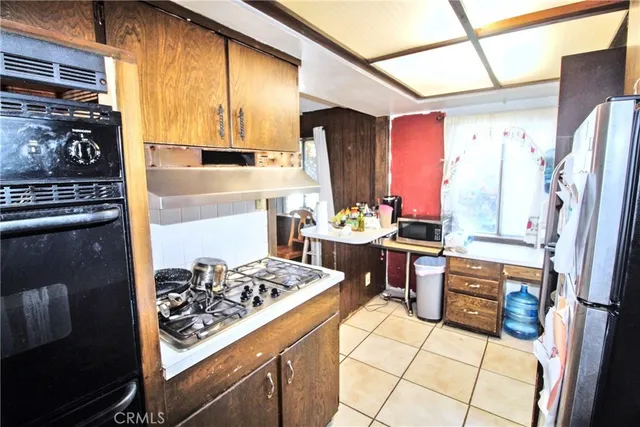 a kitchen with stainless steel appliances granite countertop a stove refrigerator and a stove