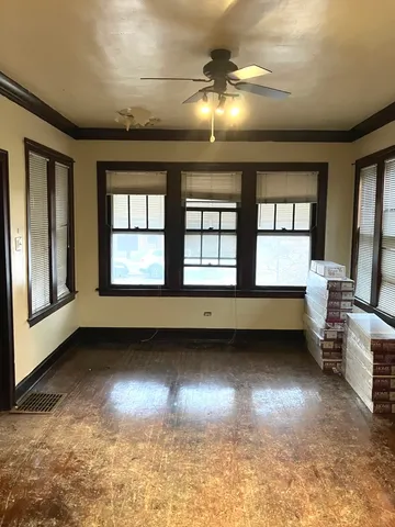 a view of a livingroom with wooden floor and a large window