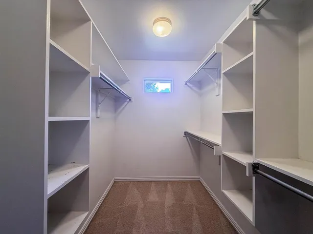 a view of an empty walk in closet