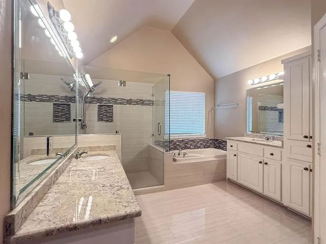 a large white kitchen with granite countertop a sink