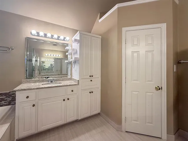 a bathroom with a granite countertop sink a mirror and a