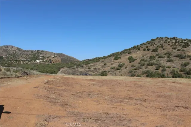 a view of a field with mountains in the background