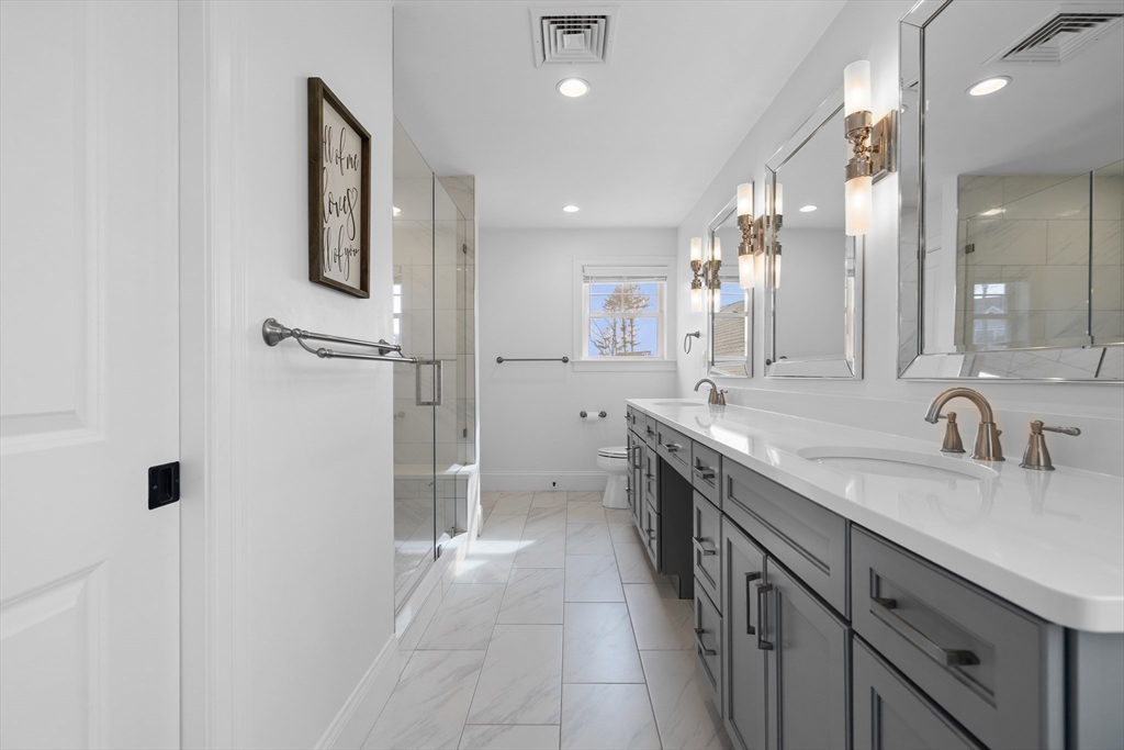 45 Rochambeau Avenue Wrentham, MA 02093 - Photo 15 of 21 a spacious bathroom with a granite countertop sink a toilet a mirror and shower