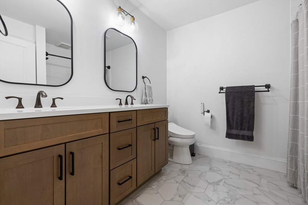 45 Rochambeau Avenue Wrentham, MA 02093 - Photo 17 of 21 a bathroom with a toilet sink and mirror