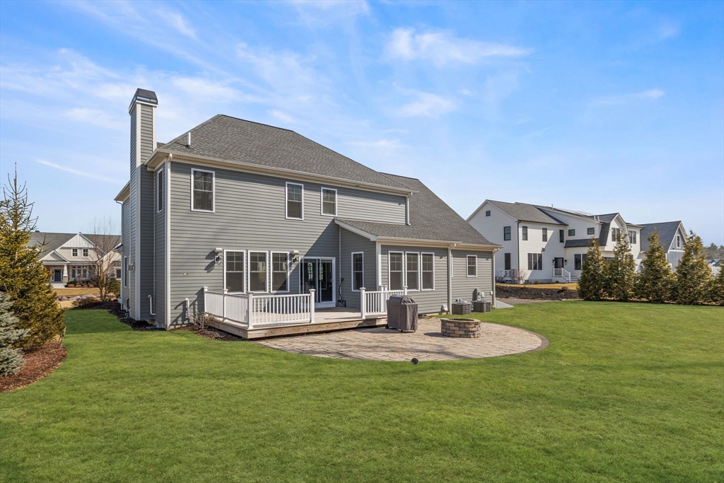 45 Rochambeau Avenue Wrentham, MA 02093 - Photo 19 of 21 a front view of a house with a yard table and chairs