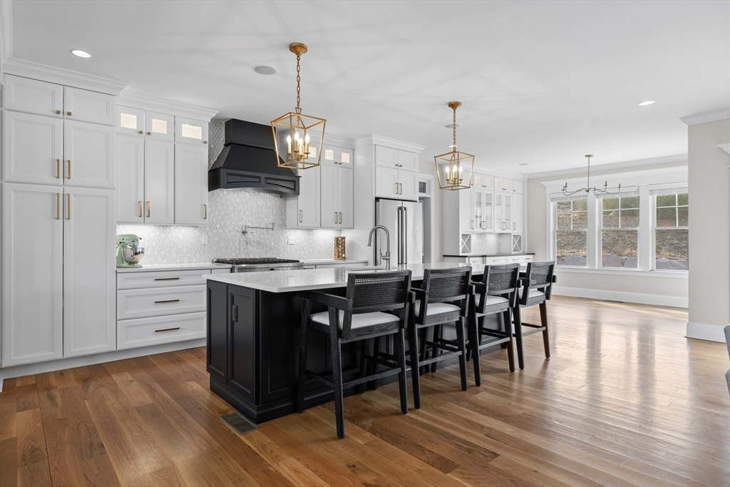 45 Rochambeau Avenue Wrentham, MA 02093 - Photo 2 of 21 a kitchen with stainless steel appliances kitchen island granite countertop a table chairs refrigerator and microwave