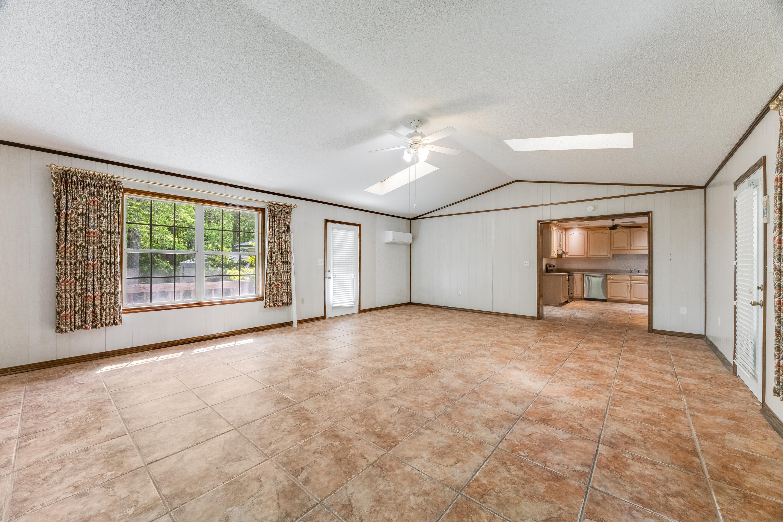 3607 Poverty Creek Road Crestview, FL 32539 - Photo 15 of 42 a view of an empty room with a window and kitchen area