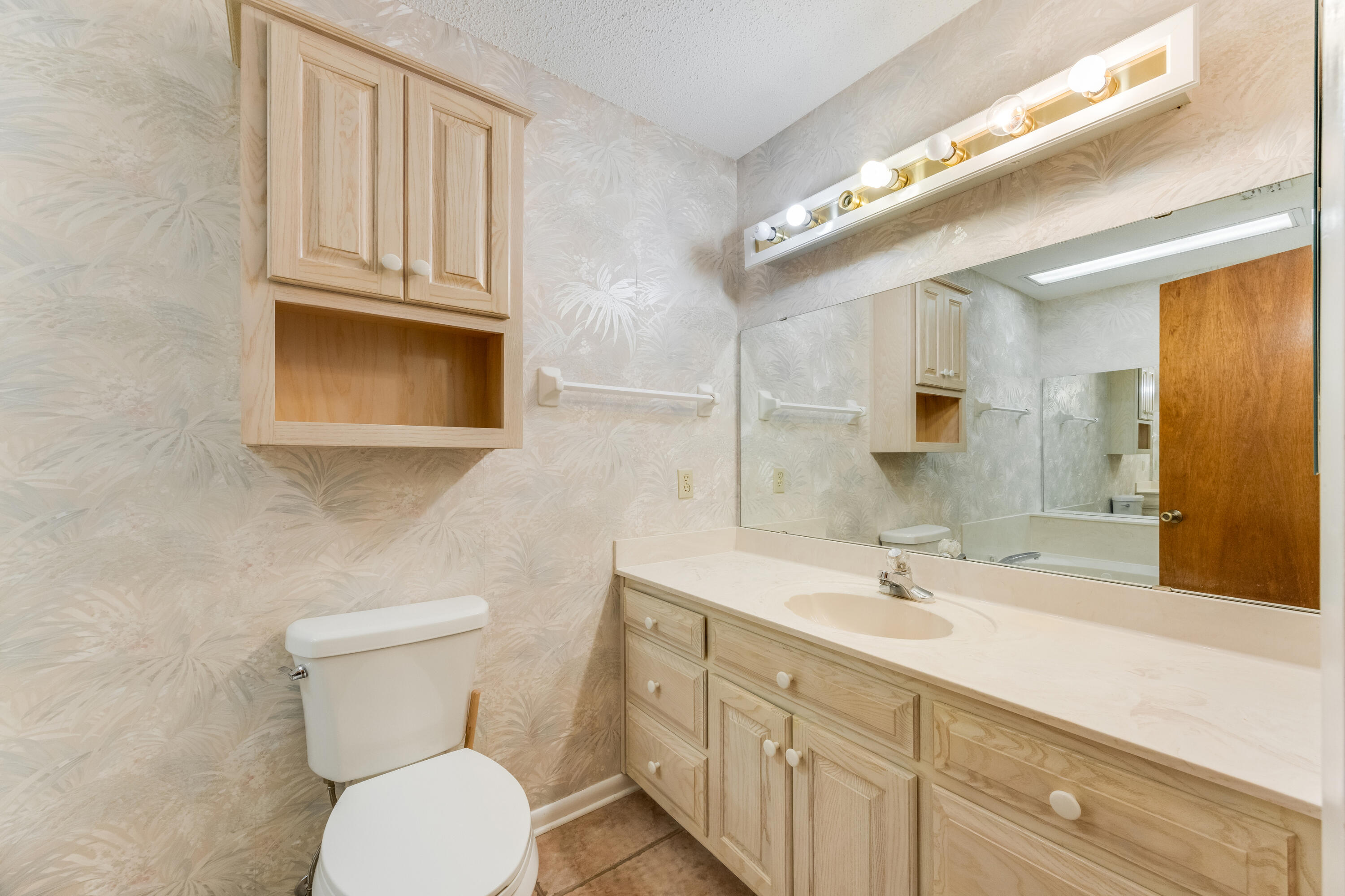 3607 Poverty Creek Road Crestview, FL 32539 - Photo 17 of 42 a bathroom with a toilet sink and mirror