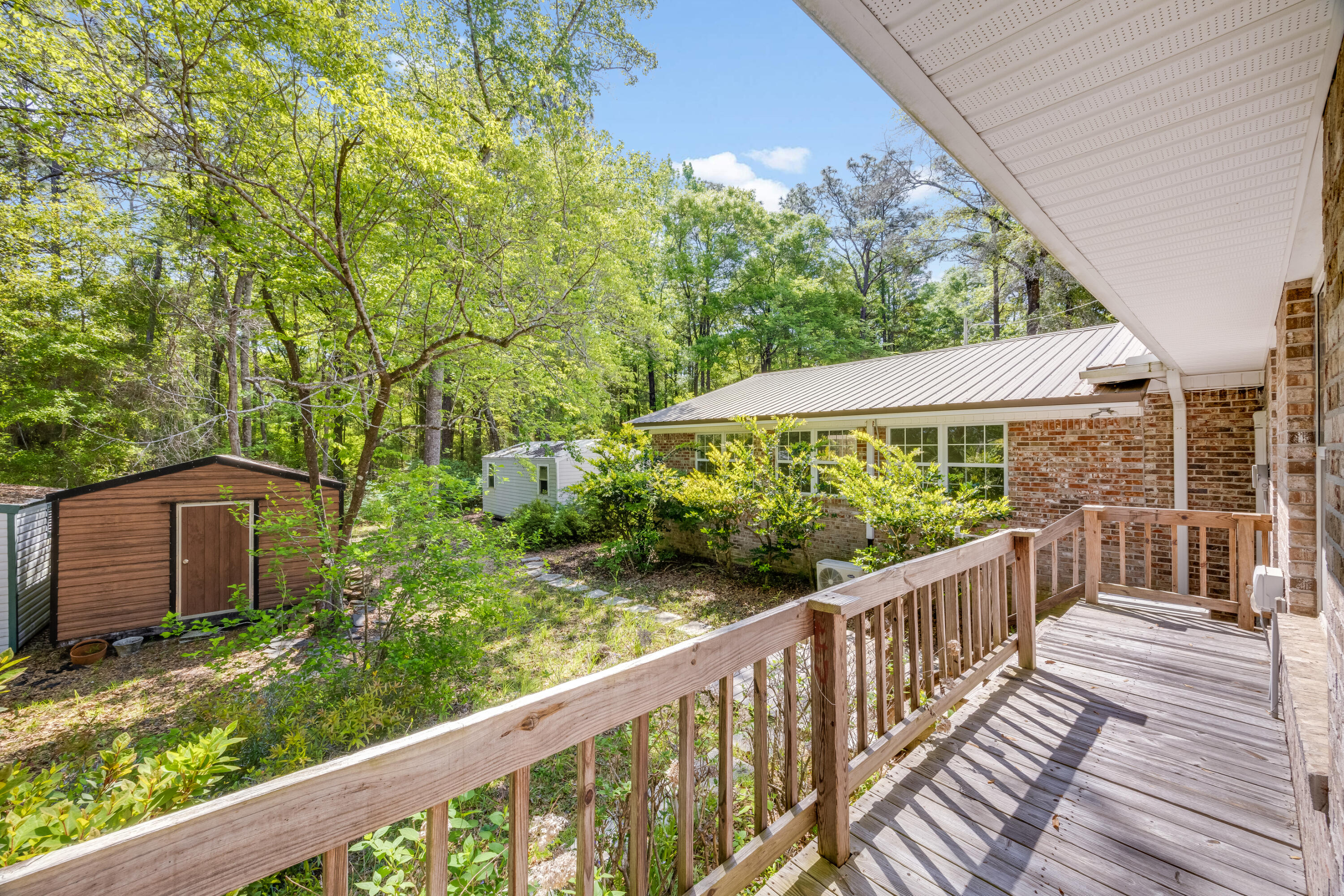 3607 Poverty Creek Road Crestview, FL 32539 - Photo 27 of 42 a view of a wooden deck next to a yard
