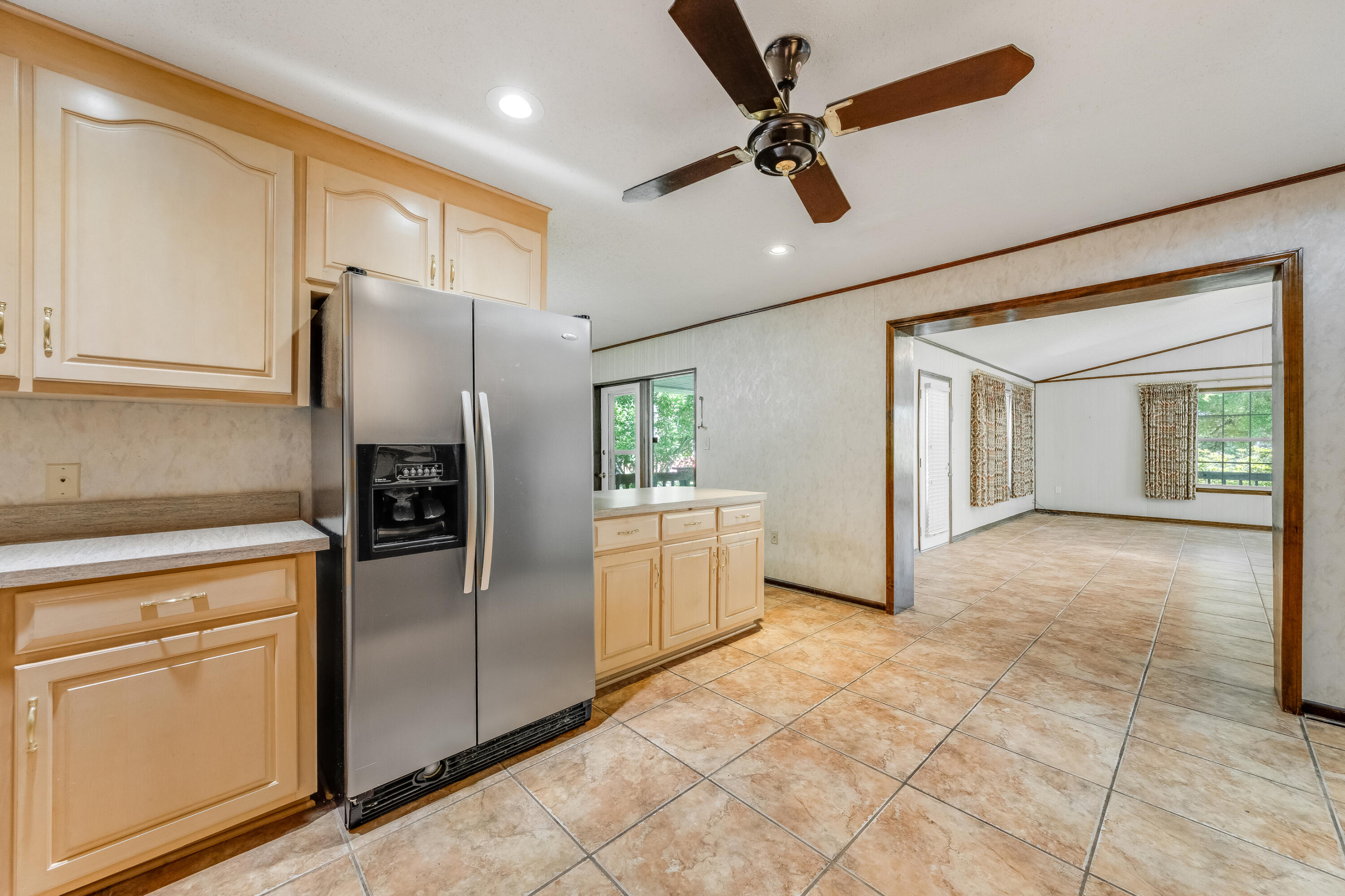 3607 Poverty Creek Road Crestview, FL 32539 - Photo 7 of 42 a kitchen with a refrigerator and white cabinets