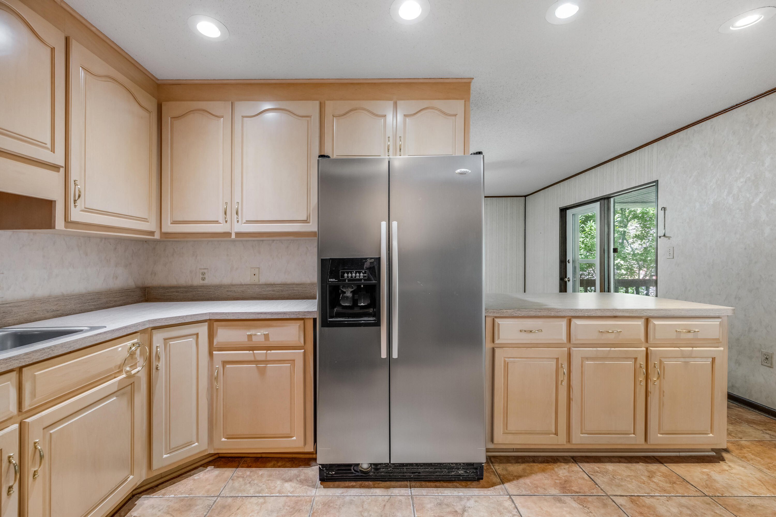 3607 Poverty Creek Road Crestview, FL 32539 - Photo 8 of 42 a kitchen with white cabinets and refrigerator