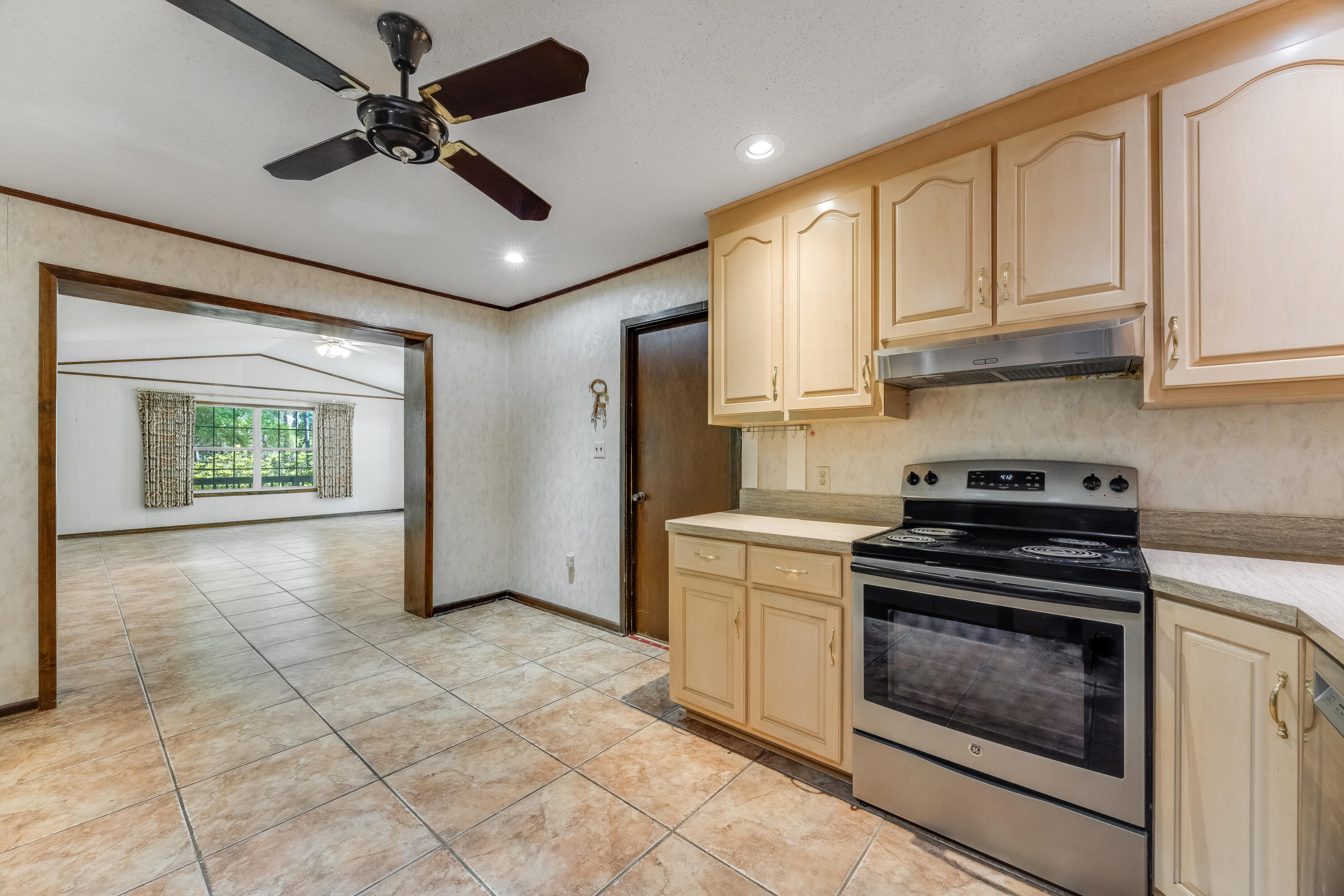 3607 Poverty Creek Road Crestview, FL 32539 - Photo 9 of 42 a kitchen with stainless steel appliances granite countertop a stove a refrigerator and a microwave oven