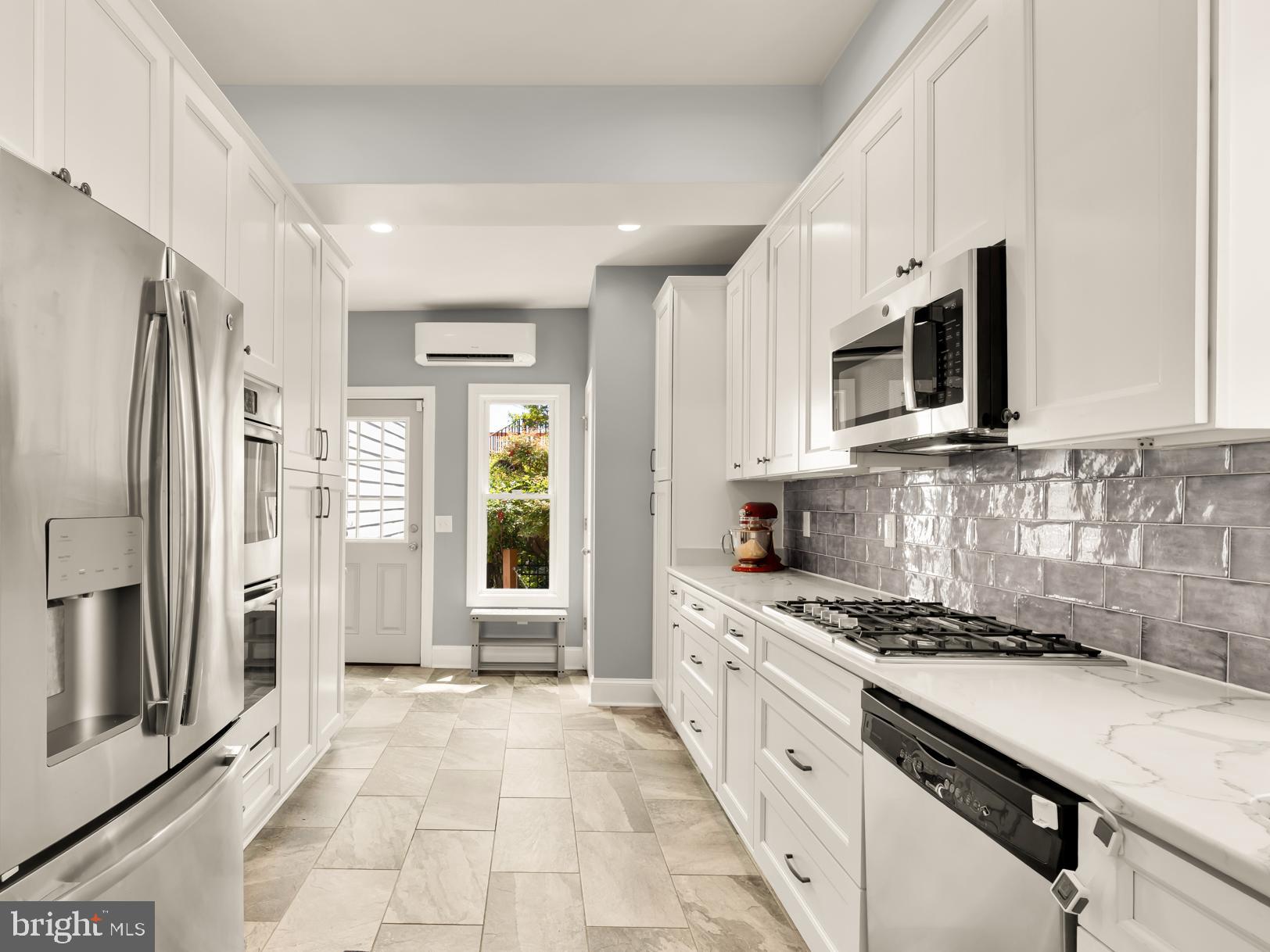 1716 Euclid Street Northwest Washington, DC 20009 - Photo 14 of 54 a kitchen with stainless steel appliances a refrigerator sink and microwave