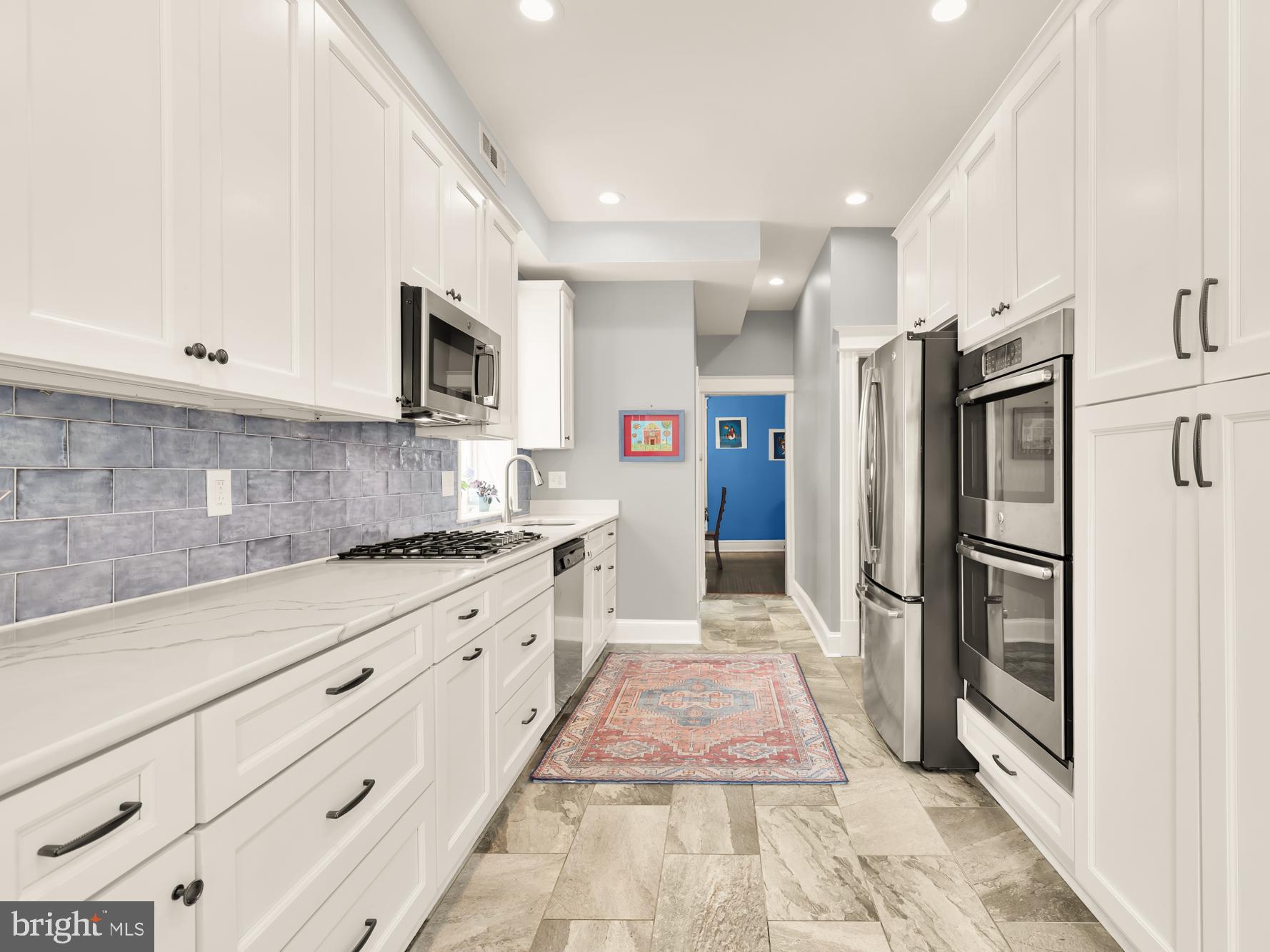 1716 Euclid Street Northwest Washington, DC 20009 - Photo 15 of 54 a large kitchen with stainless steel appliances granite countertop a refrigerator and a stove