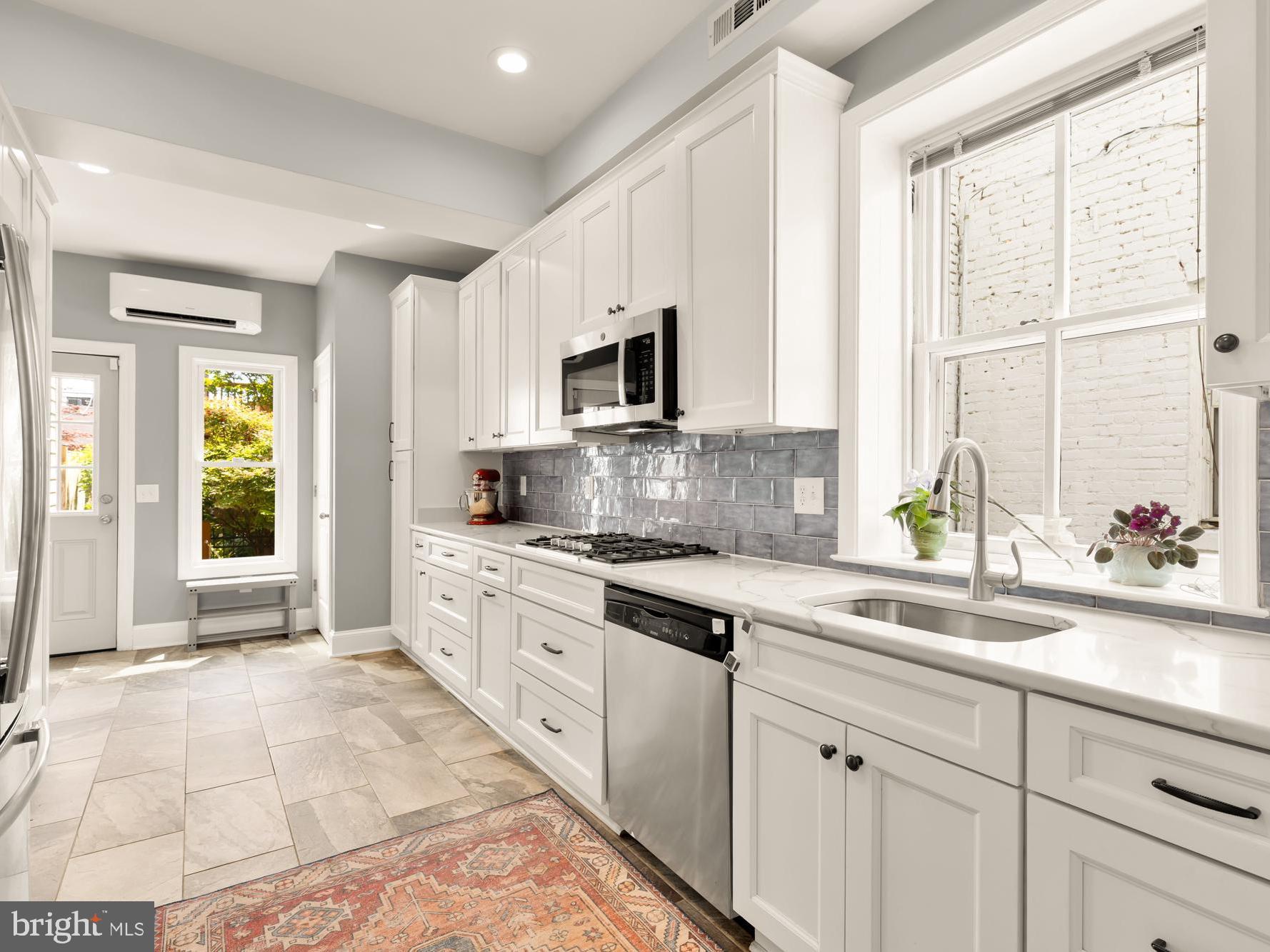 1716 Euclid Street Northwest Washington, DC 20009 - Photo 18 of 54 a kitchen with a stove a sink and a window
