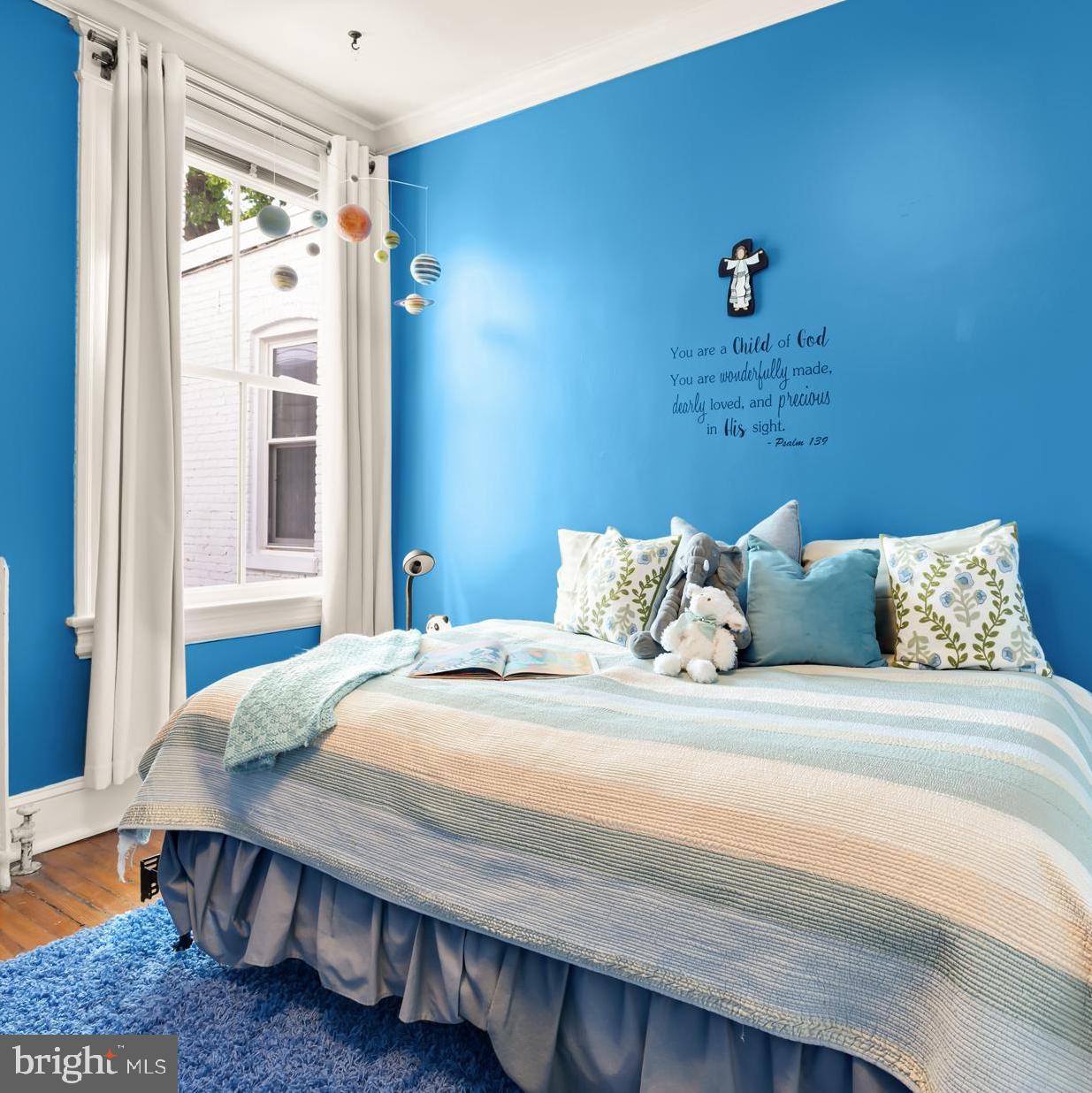 1716 Euclid Street Northwest Washington, DC 20009 - Photo 27 of 54 a bedroom with a bed and wooden floor