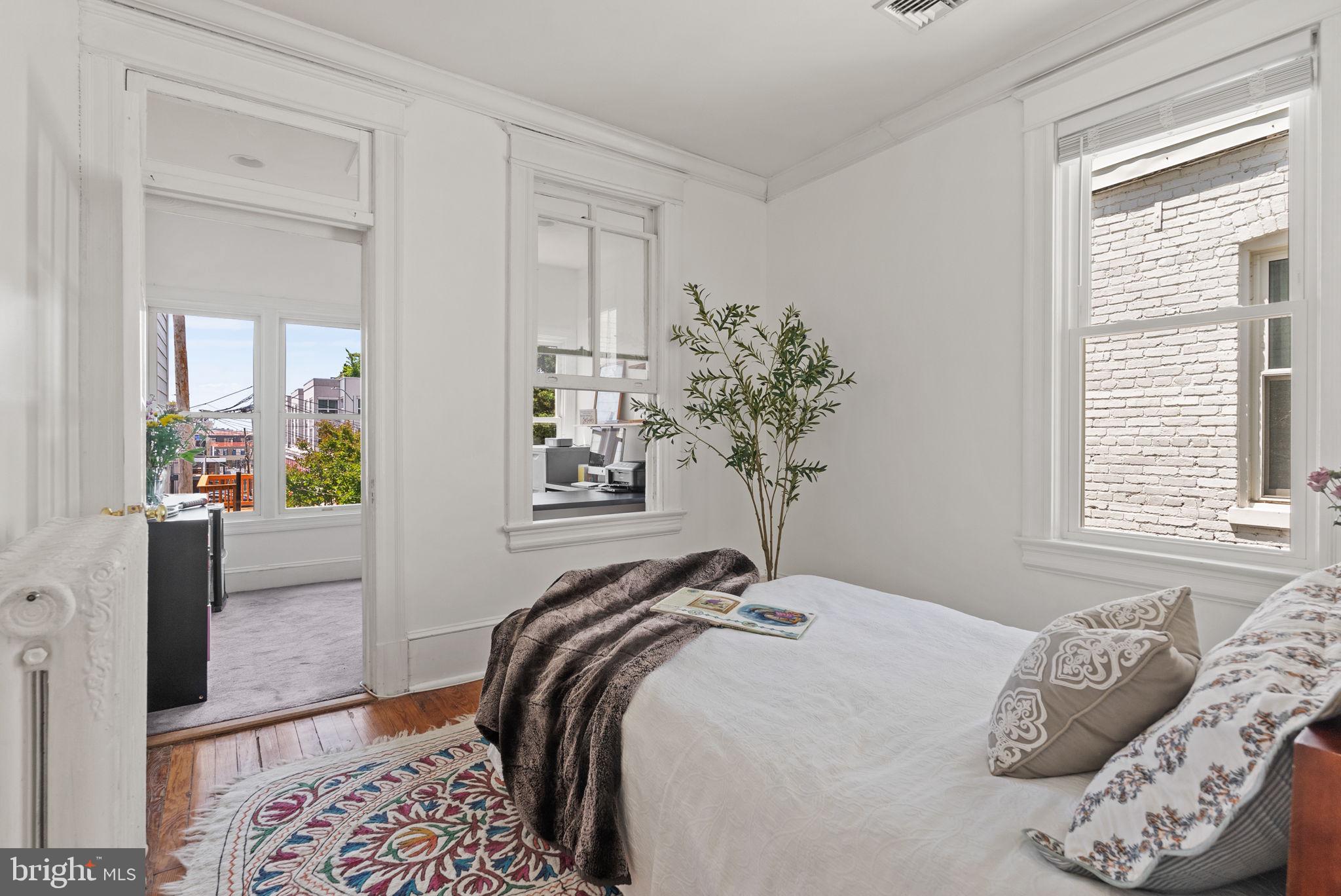 1716 Euclid Street Northwest Washington, DC 20009 - Photo 29 of 54 a bedroom with a bed and a window