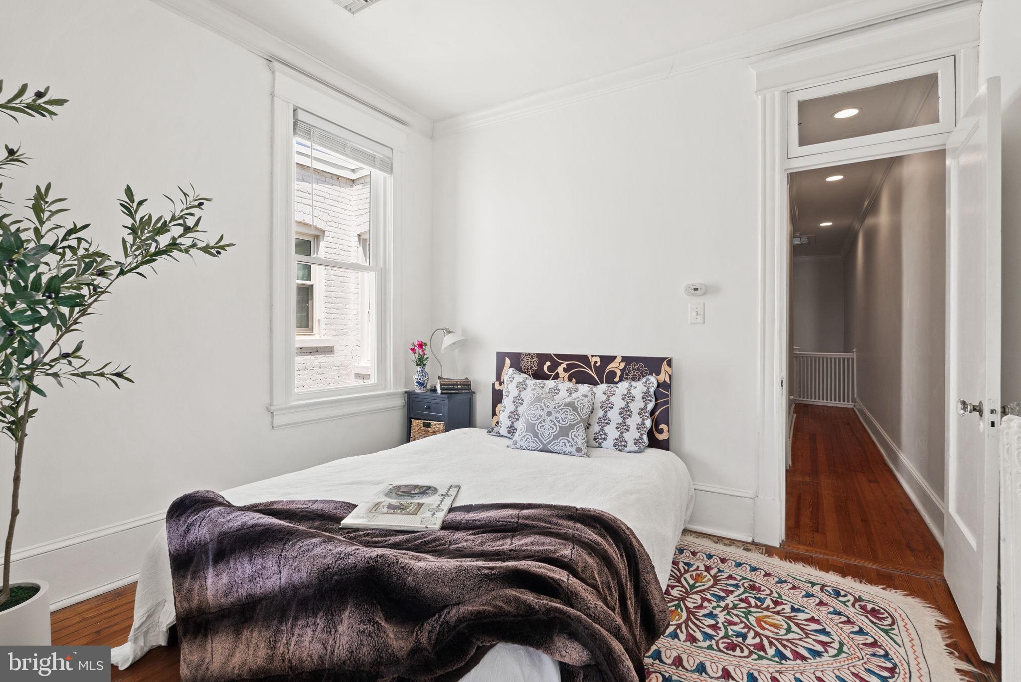 1716 Euclid Street Northwest Washington, DC 20009 - Photo 30 of 54 a bedroom with a bed and a window