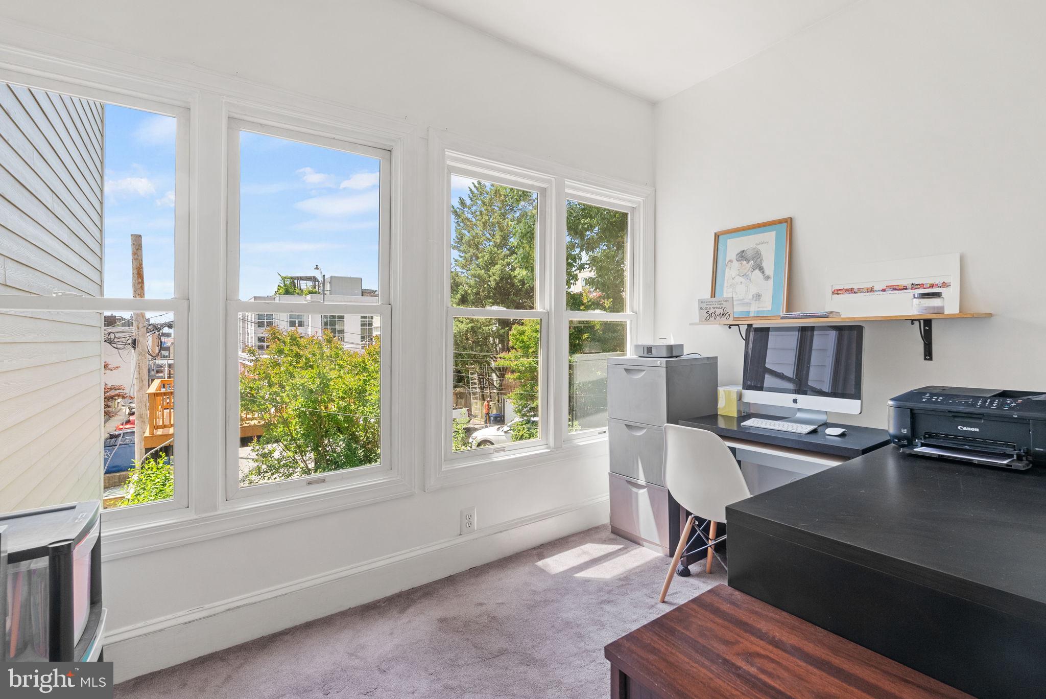 1716 Euclid Street Northwest Washington, DC 20009 - Photo 31 of 54 a workspace with furniture and a window