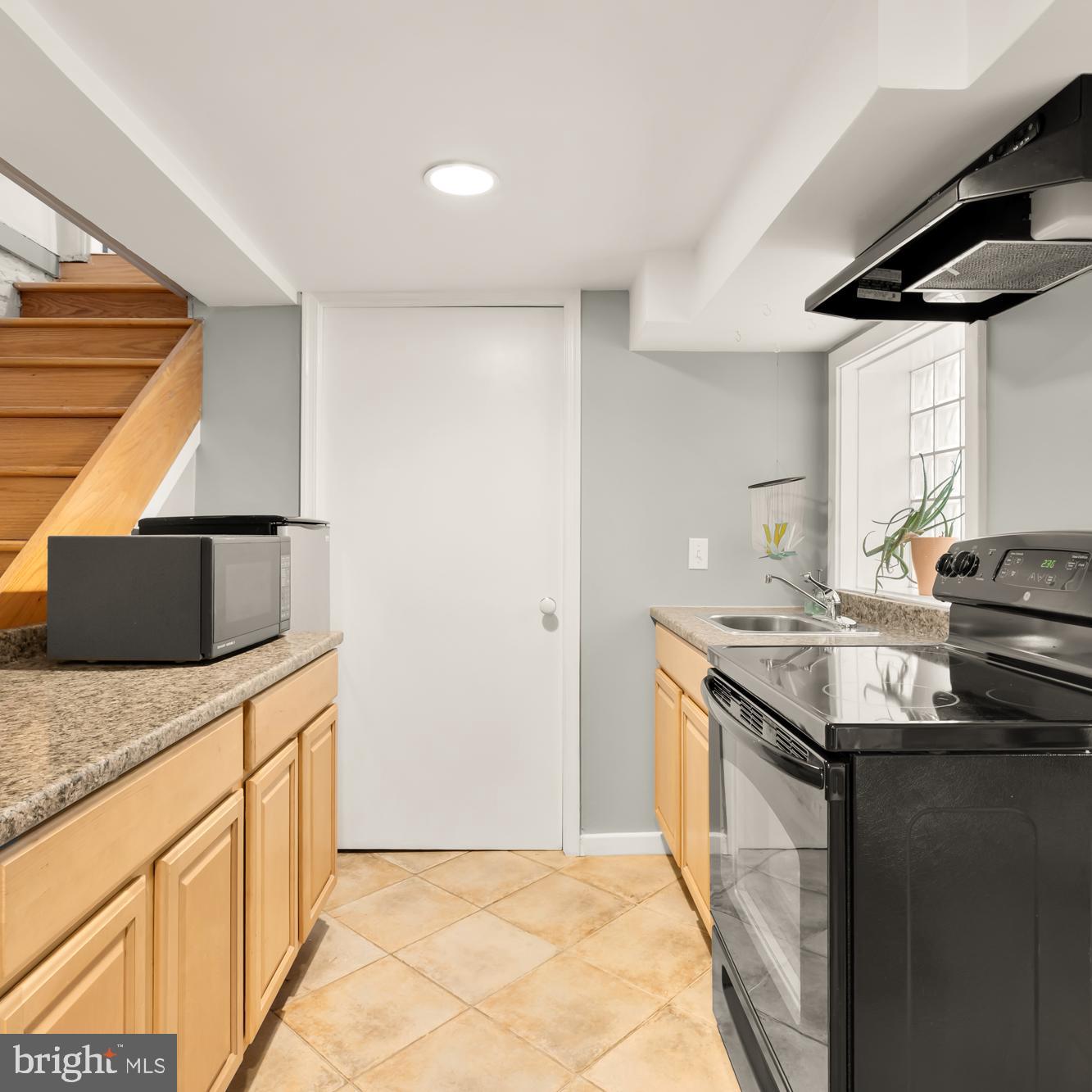 1716 Euclid Street Northwest Washington, DC 20009 - Photo 36 of 54 a kitchen with stainless steel appliances granite countertop a sink and a stove