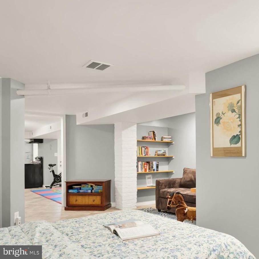 1716 Euclid Street Northwest Washington, DC 20009 - Photo 37 of 54 a bedroom with furniture and a book shelf