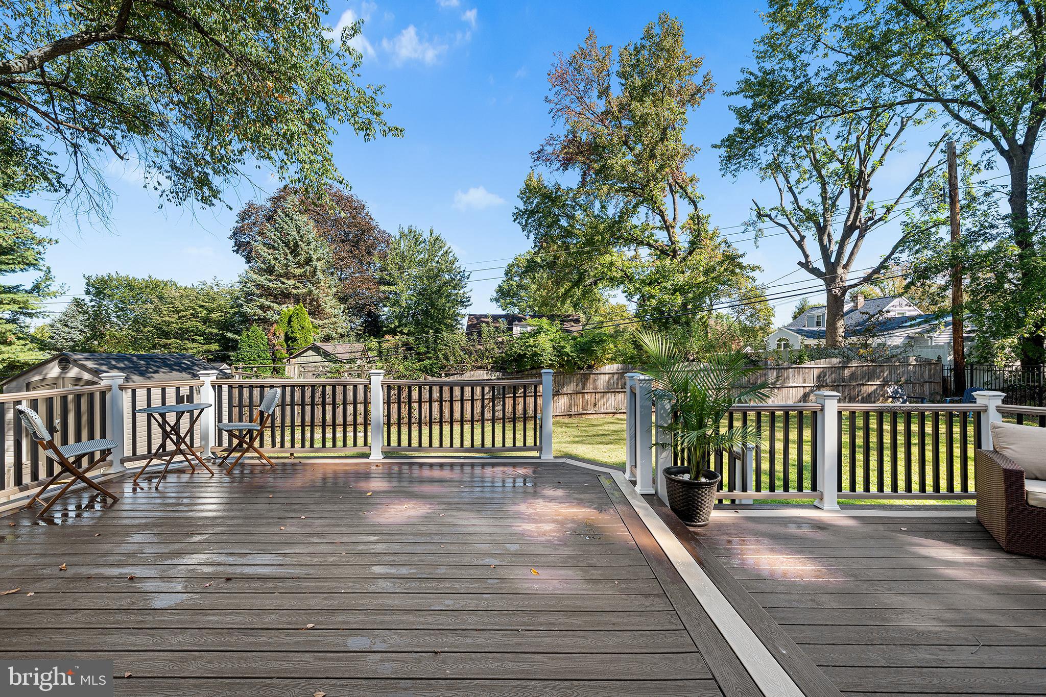 1203 Wedgewood Road Flourtown, PA 19031 - Photo 12 of 25 a view of a deck with a floor to ceiling window and wooden fence
