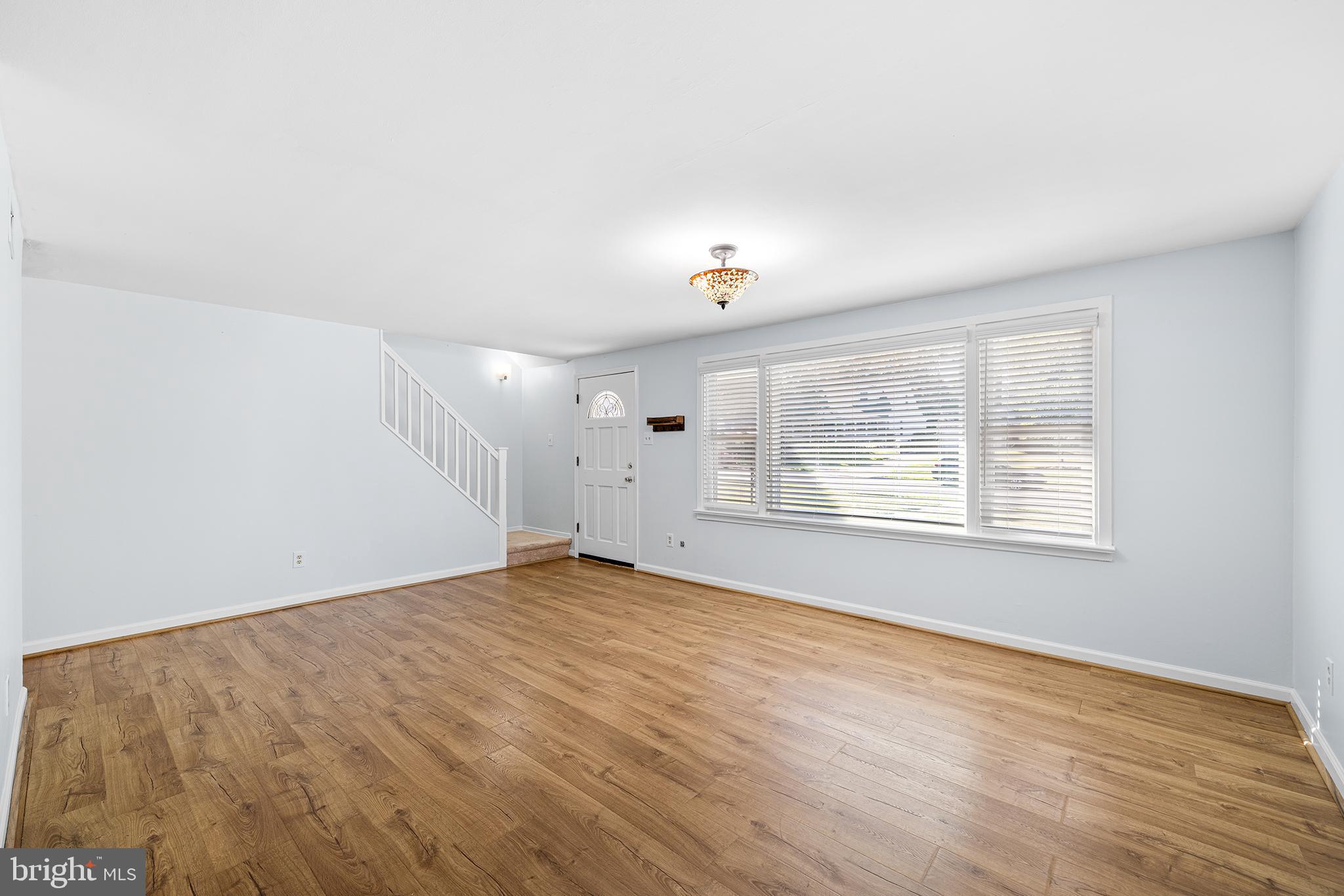 1203 Wedgewood Road Flourtown, PA 19031 - Photo 4 of 25 a view of an empty room with wooden floor and a window