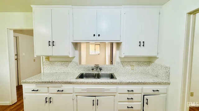 a sink with white cabinets