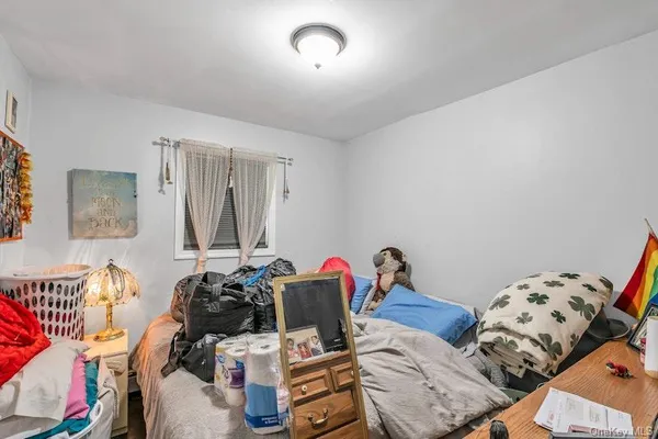 a bedroom with furniture and a flat screen tv