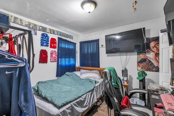 a view of a living room with clothes and shoes