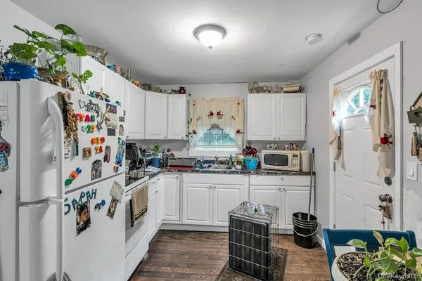 a kitchen with refrigerator and cabinets