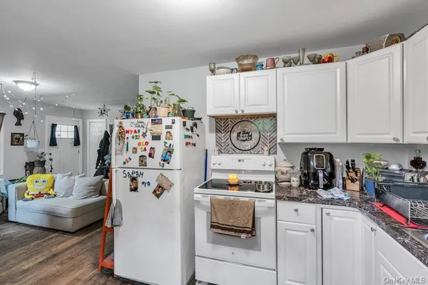 a bedroom with bed and a wooden floor