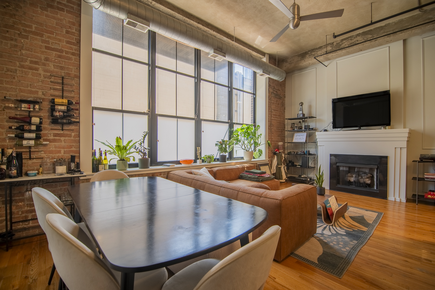 817 West Washington Boulevard, Unit 102 Chicago, IL 60607 - Photo 3 of 10 a dining room with furniture a fireplace and wooden floor
