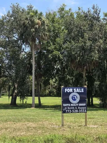 a sign broad in front of the tree