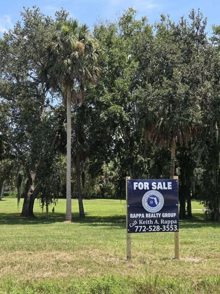 0 Southwest 16th Drive Okeechobee, FL 34974 - Photo 2 of 7 a sign broad in front of the tree