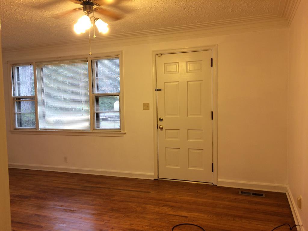2833 Christine Road Columbus, GA 31907 - Photo 3 of 18 an empty room with wooden floor fan and windows