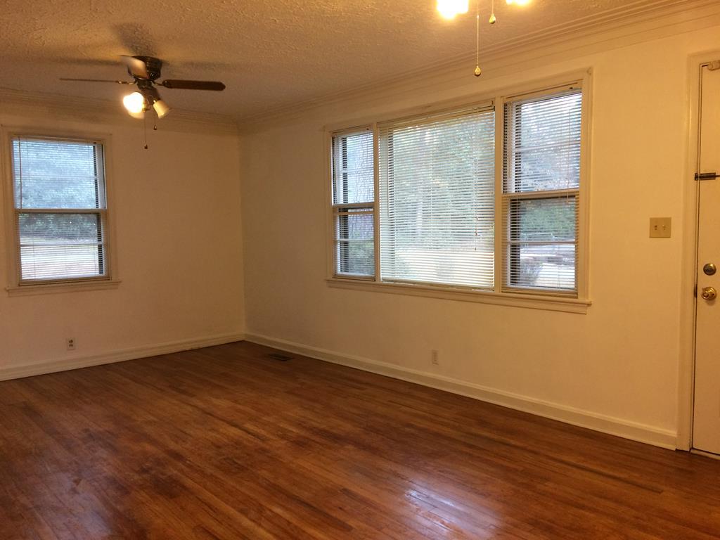 2833 Christine Road Columbus, GA 31907 - Photo 4 of 18 a view of an empty room with wooden floor and a window