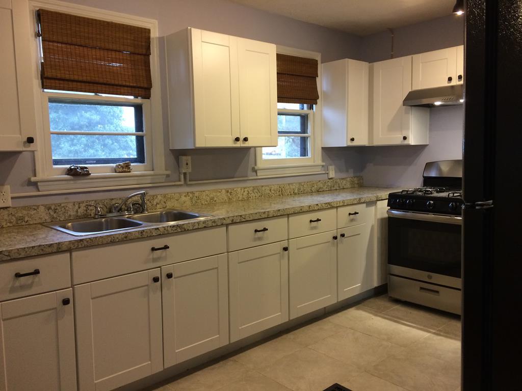 2833 Christine Road Columbus, GA 31907 - Photo 6 of 18 a kitchen with granite countertop white cabinets and white appliances
