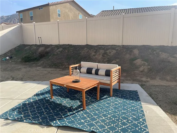 a backyard of a house with table and chairs