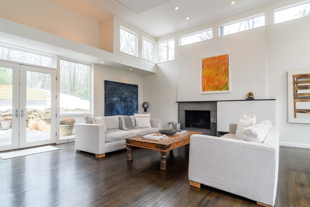 41 Grove Street Wayland, MA 01778 - Photo 10 of 24 a living room with fireplace furniture and a large window
