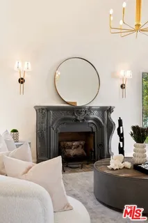 a dining room with wooden floor a chandelier a glass table and chairs