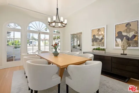 a view of a dining room with furniture wooden floor and chandelier