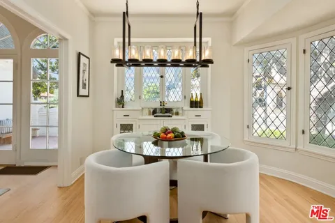 a living room with furniture and floor to ceiling windows