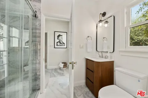 a spacious bedroom with a bed and a window