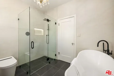 a bathroom with a double vanity sink a mirror and a shower
