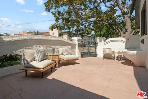 a view of a patio with swimming pool and sitting area